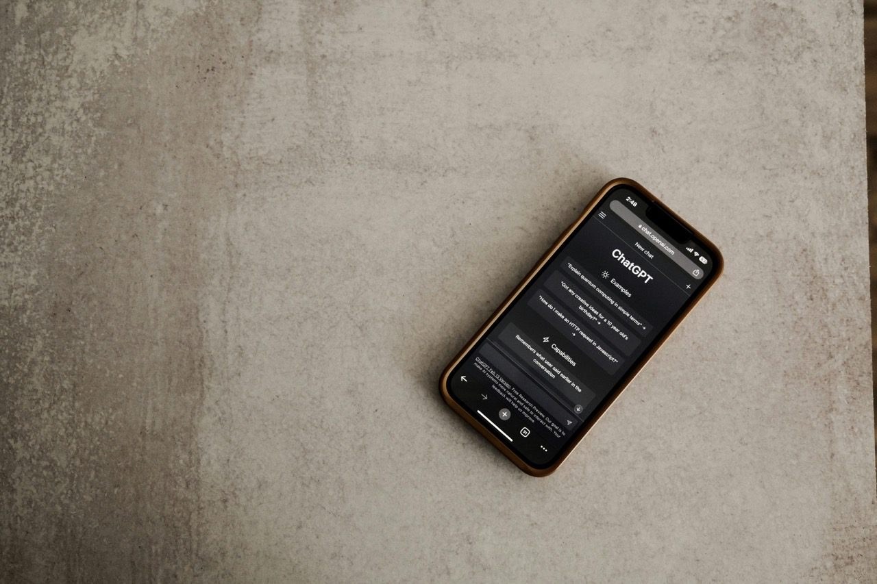 An iPhone resting on a concrete surface with the ChatGPT app open.