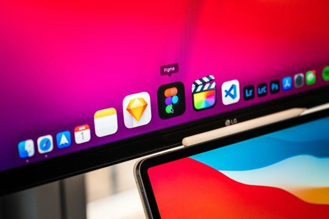 A close-up of the Figma icon in a Mac dock, with an iPad Pro in the foreground.